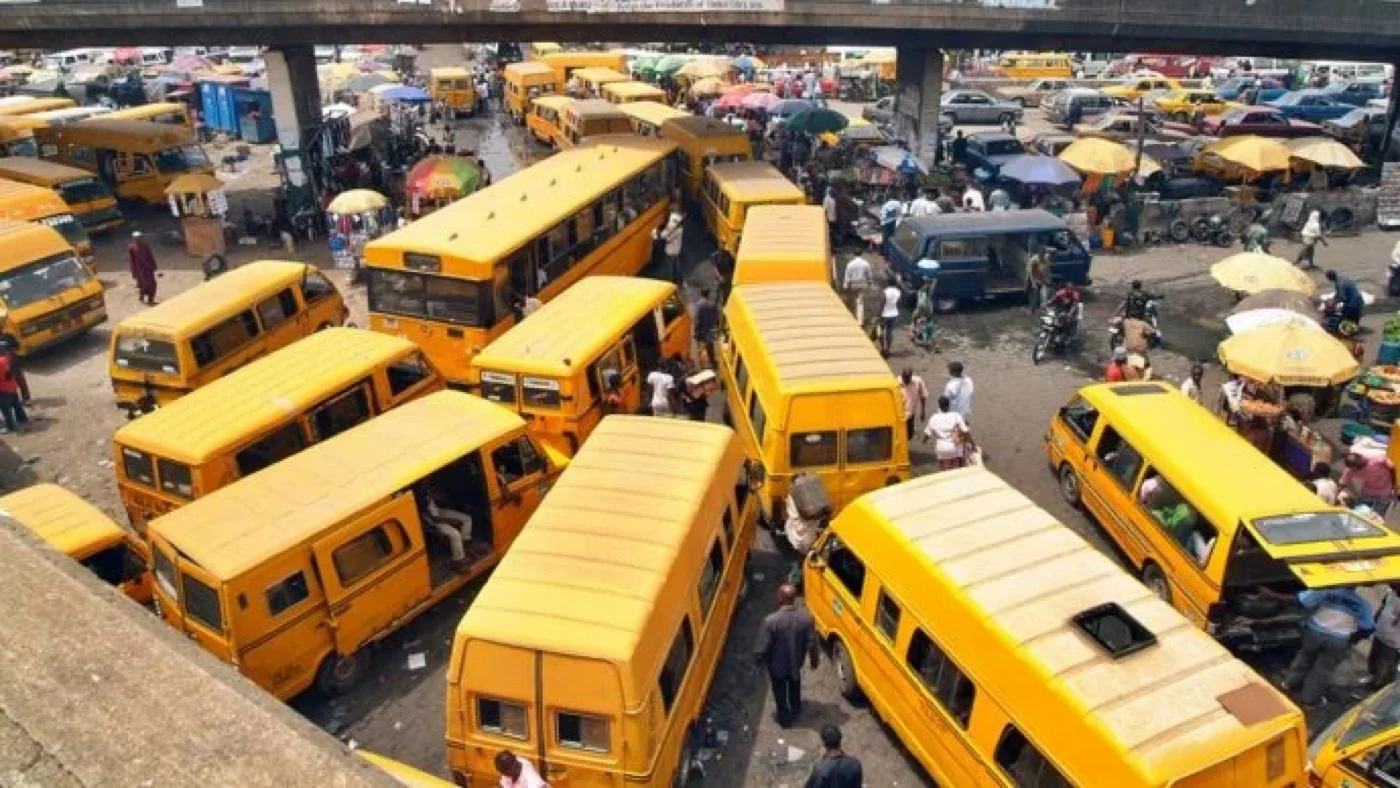 A crowded Lagos motor park filled with danfo buses — the disorganised status quo Soole set out to improve